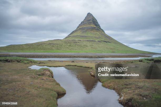 famous kirkjufell mountain in iceland against overcast sky, no people - west central iceland stock pictures, royalty-free photos & images