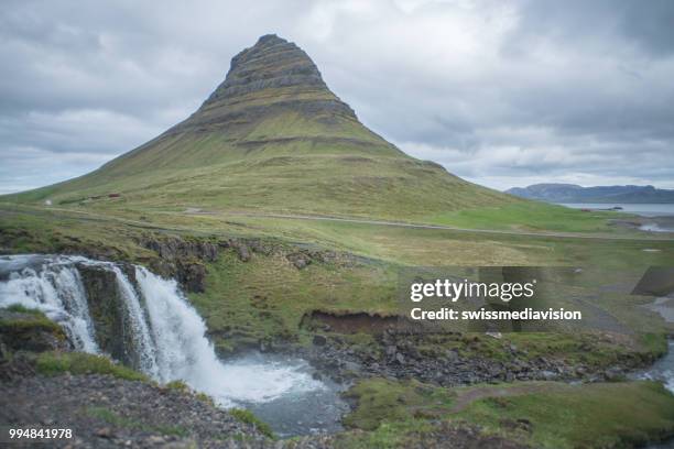 spectacular kirkjufell mountain and waterfall kirkjufellsfoss in iceland against overcast sky, no people - west central iceland stock pictures, royalty-free photos & images