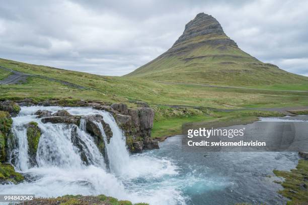 spectacular kirkjufell mountain and waterfall kirkjufellsfoss in iceland against overcast sky, no people - west central iceland stock pictures, royalty-free photos & images