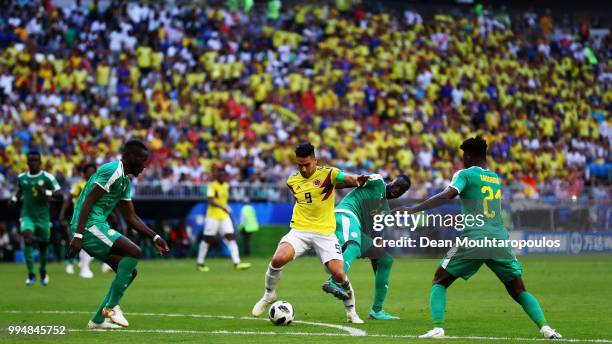 Salif Sane, Cheikhou Kouyate and Lamine Gassama of Senegal attempt to stop Radamel Falcao Garcia of Colombia during the 2018 FIFA World Cup Russia...