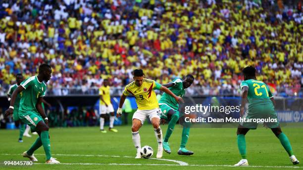 Salif Sane, Cheikhou Kouyate and Lamine Gassama of Senegal attempt to stop Radamel Falcao Garcia of Colombia during the 2018 FIFA World Cup Russia...