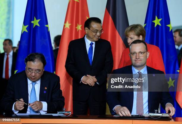 German Health Minister Jens Spahn and Chinese Health Minister Ma Xiaowei sign an agreement as they attend a signing ceremony within the 5th...