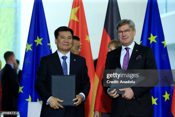 Of SAP Michael Kleinemeier and Suning Holdings Group President Zhang Jindong sign an agreement as they attend a signing ceremony within the 5th...