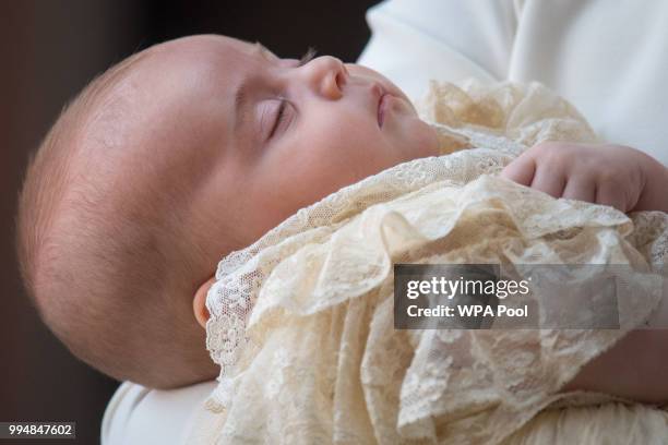 Catherine, Duchess of Cambridge carries Prince Louis Of Cambridge as they arrive for his christening service at St James's Palace on July 09, 2018 in...