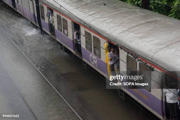 Train seen running through a flooded railway track. Heavy rains across Mumbai city and adjoining areas continue for 3rd consecutive day and affect...