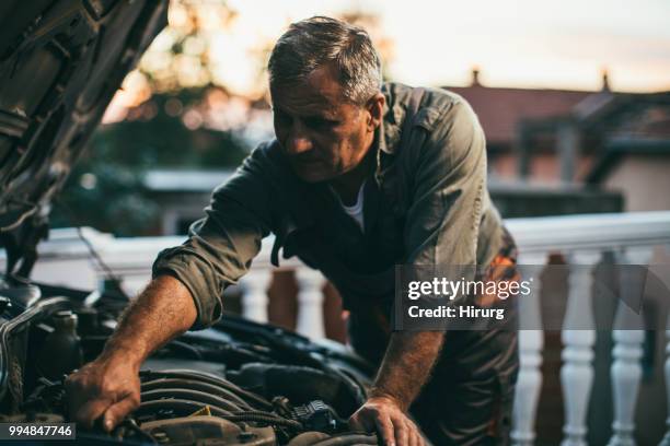 mechanic repairing car - old garage at home stock pictures, royalty-free photos & images