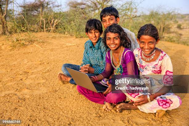 happy indian children using laptop, desert village, india - laptop desert stock pictures, royalty-free photos & images