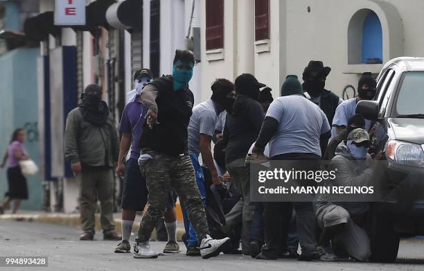 Paramilitaries surround the San Sebastian Basilica, in Diriamba, Nicaragua on July 09, 2018. - Armed supporters of the government of Nicaraguan...
