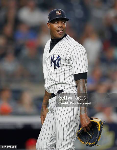 Pitcher Aroldis Chapman of the New York Yankees reacts as he sees a fly ball hit by Kurt Suzuki that was caught for the last out of the game and the...