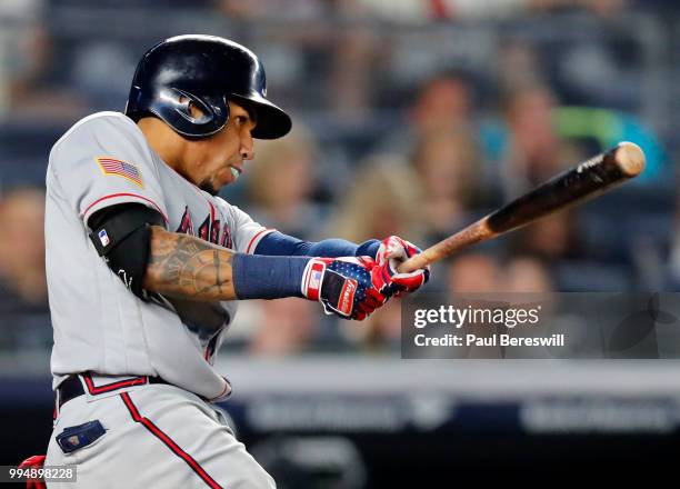 Johan Camargo of the Atlanta Braves blows a bubble with his bubble gum as he hits a single in an interleague MLB baseball game against the New York...