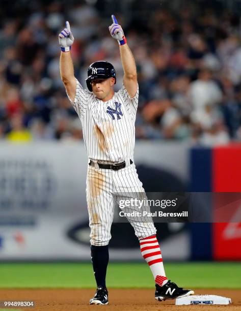 Brett Gardner of the New York Yankees gestures from second base after hitting a double in the fourth inning in an interleague MLB baseball game...