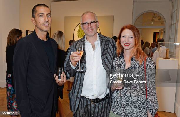 Wissam al Mana, Joe Corre and Claire English attend the Bansky 'Greatest Hits 2002-2008" exhibition VIP preview at Lazinc on July 9, 2018 in London,...