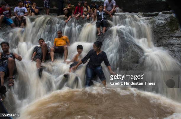 People enjoy in the water at Kanheri Caves water Fall on July 8, 2018 in Mumbai, India. Heavy monsoon rains lashed the megapolis and its neighboring...