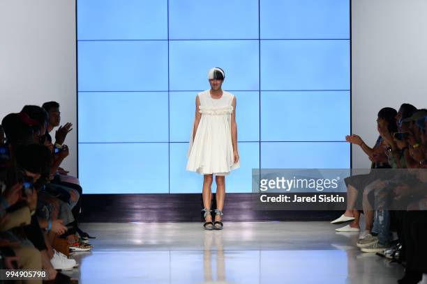 Designer Alessandro Trincone greets crowd after the finale at the Alessandro Trincone fashion show during Men's Fashion Week at Cadillac House on...