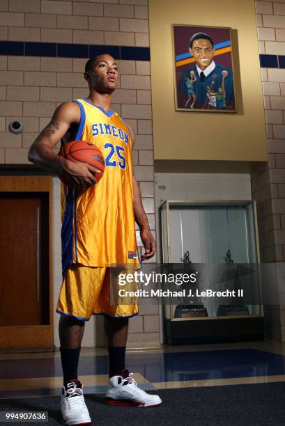 High School Basketball: Closeup portrait of Simeon Career Academy Derrick Rose at Ben Wilson Gymnasium. View of Ben Wilson painting in background....