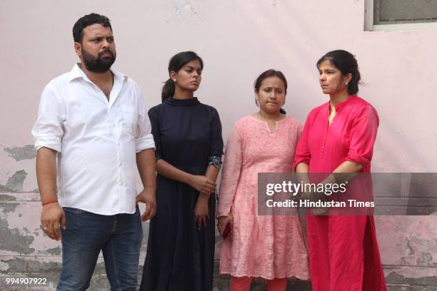 Wife and daughter of of Gangster Prem Prakash Singh alias Munna Bajrangi and family members, wait outside District hospitals post-mortem house on...