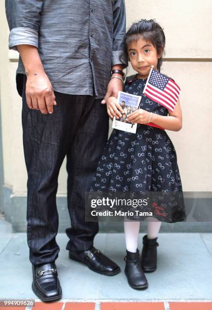 Young U.S. Citizen Darina Cruz originally from Mexico, poses with her father following a celebration where she received her citizenship papers at the...
