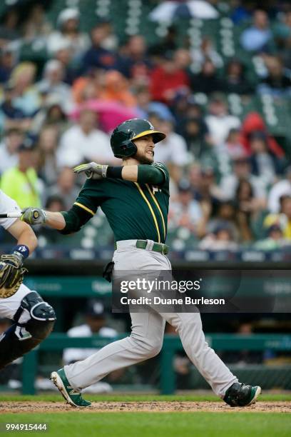 Jed Lowrie of the Oakland Athletics hits an RBI-double during the fourth inning of a game against the Detroit Tigers at Comerica Park on June 27,...