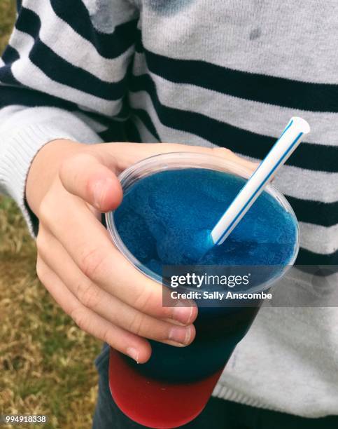 child hold a slushy ice drink - sally anscombe stock-fotos und bilder