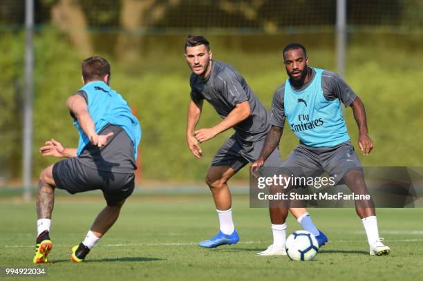 Sead Kolasinac and Alex Lacazette of Arsenal compete for the ball during a training session at London Colney on July 9, 2018 in St Albans, England.