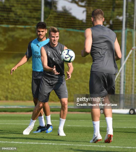 Rob Holding and Calum Chambers of Arsenal warm up during a training session at London Colney on July 9, 2018 in St Albans, England.