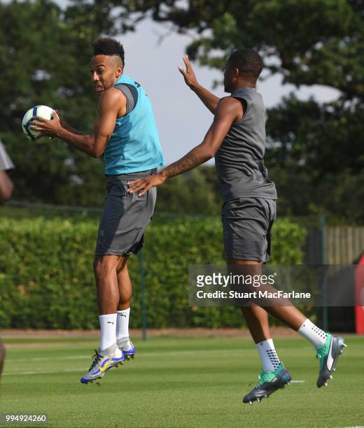 Pierre-Emerick Aubameyang and Chuba Akpom of Arsenal share a joke during a training session at London Colney on July 9, 2018 in St Albans, England.