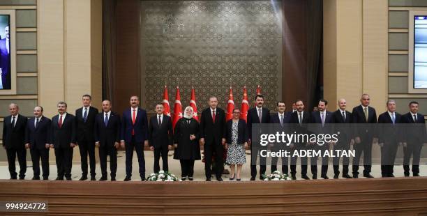 Turkey's President Recep Tayyip Erdogan , poses with the members of the newly presented cabinet following a news conference at the Presidential...