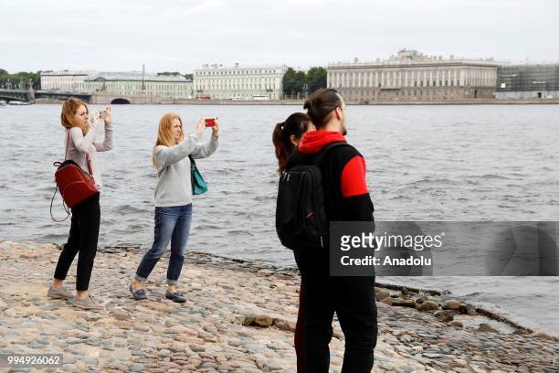 People take pictures of Neva River in Saint Petersburg, Russia on July 09, 2018.
