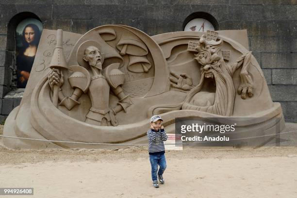 Boy is seen in front of a sand sculpture along the Neva River in Saint Petersburg, Russia on July 09, 2018.