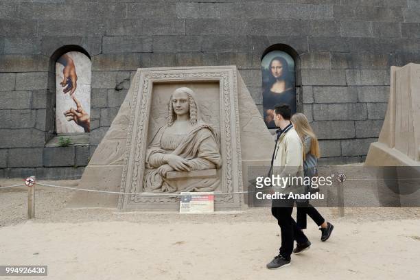 People view the sand sculptures along the Neva River in Saint Petersburg, Russia on July 09, 2018.