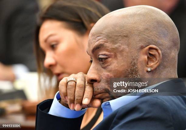 Plaintiff Dewayne Johnson listens as attorney Brent Wisner speaks about his condition during the Monsanto trial in San Francisco, California on July...