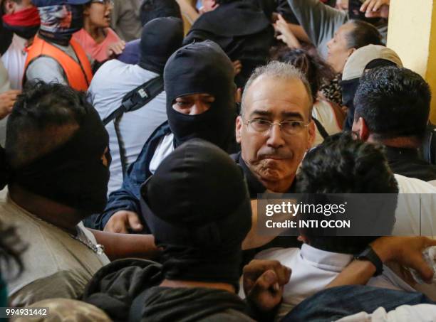 Catholic priest Edwin Roman is attacked by members of the pro-government Sandinista youth at the San Sebastian Basilica in Diriamba, Nicaragua, on...