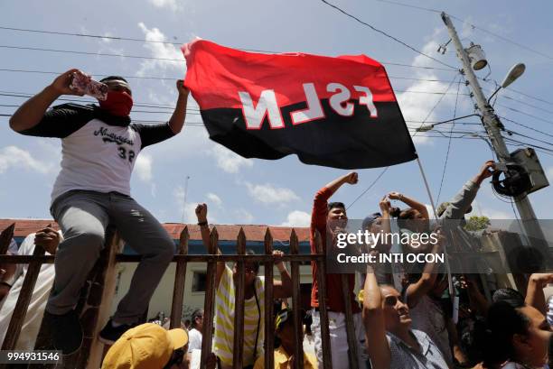 Members of the pro-government Sandinista youth shout slogans at members of the church at the San Sebastian Basilica in Diriamba, Nicaragua, on July...