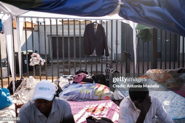 Migrants and refugees stay outside a building after being evicted 4 days ago by Italian Police, on July 9, 2018 in Rome, Italy. About 120 African...