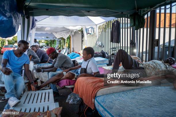 Migrants and refugees stay outside a building after being evicted 4 days ago by Italian Police, on July 9, 2018 in Rome, Italy. About 120 African...