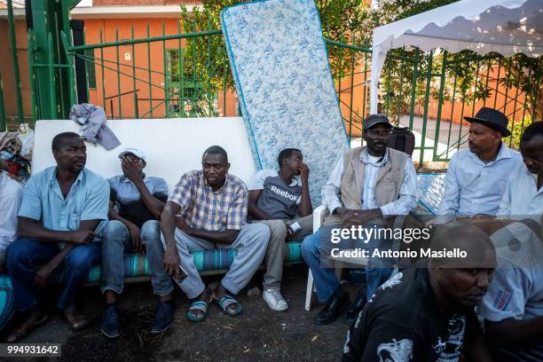 Migrants and refugees stay outside a building after being evicted 4 days ago by Italian Police, on July 9, 2018 in Rome, Italy. About 120 African...