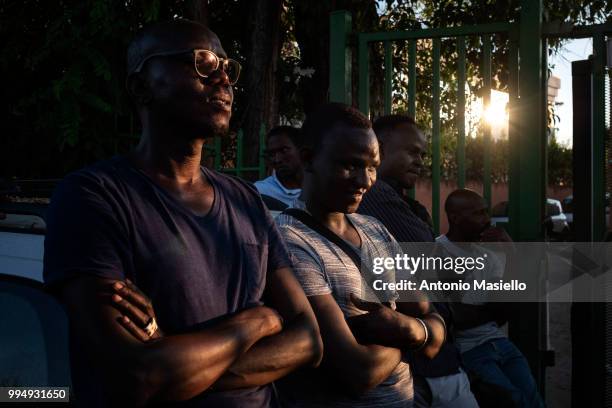 Migrants and refugees stay outside a building after being evicted 4 days ago by Italian Police, on July 9, 2018 in Rome, Italy. About 120 African...