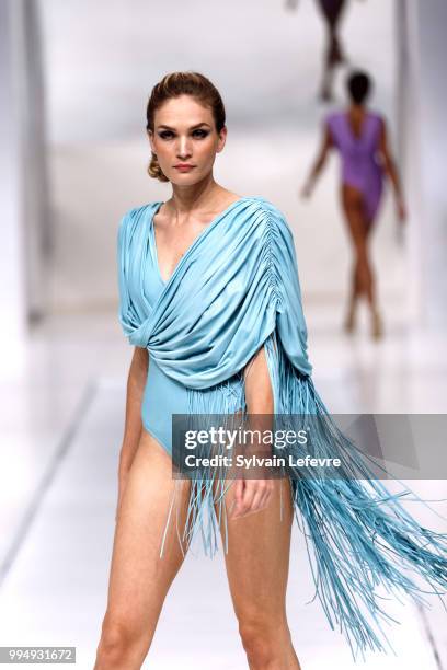 Model presents swimwear creation at the International Exhibition of Lingerie, 'Salon De La Lingerie' Summer Collection at Parc des Expositions Porte...