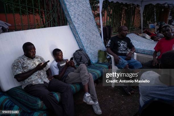 Migrants and refugees stay outside a building after being evicted 4 days ago by Italian Police, on July 9, 2018 in Rome, Italy. About 120 African...