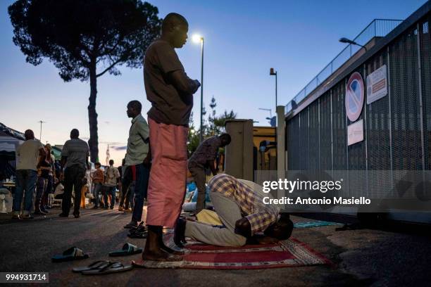 Migrants and refugees pray on a street after being evicted 4 days ago by Italian Police, on July 9, 2018 in Rome, Italy. About 120 African migrants...