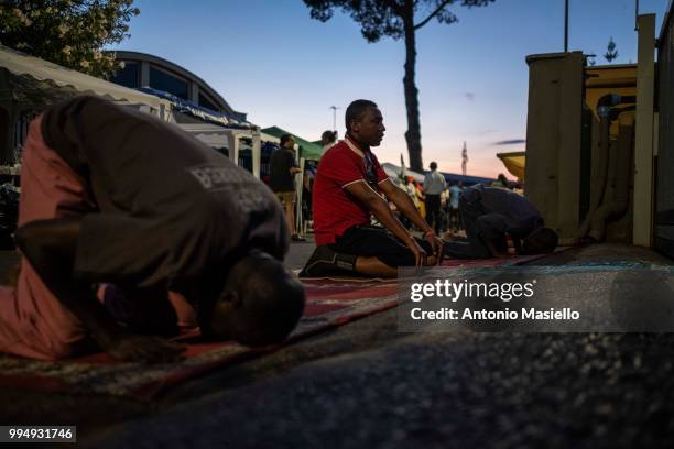 Migrants and refugees pray on a street after being evicted 4 days ago by Italian Police, on July 9, 2018 in Rome, Italy. About 120 African migrants...