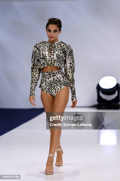 Model presents swimwear creation at the International Exhibition of Lingerie, 'Salon De La Lingerie' Summer Collection at Parc des Expositions Porte...