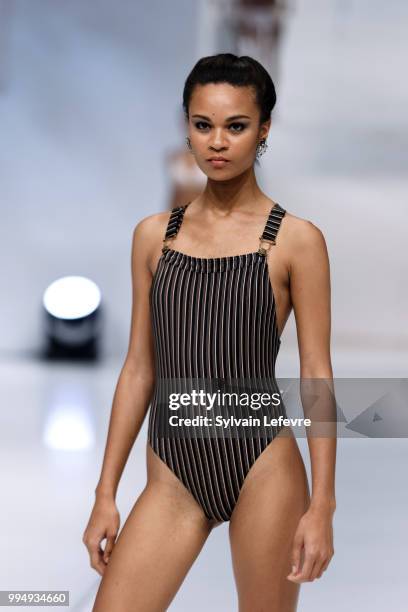 Model presents swimwear creation at the International Exhibition of Lingerie, 'Salon De La Lingerie' Summer Collection at Parc des Expositions Porte...