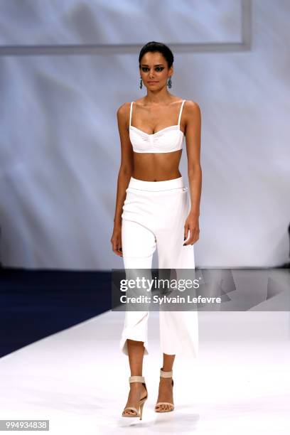 Model presents swimwear creation at the International Exhibition of Lingerie, 'Salon De La Lingerie' Summer Collection at Parc des Expositions Porte...