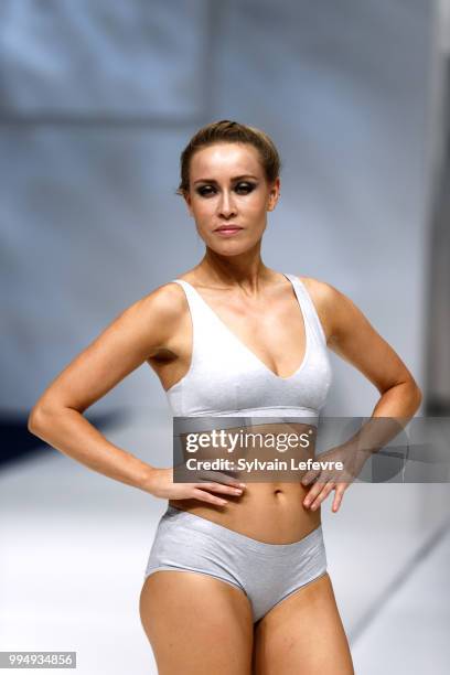 Model presents swimwear creation at the International Exhibition of Lingerie, 'Salon De La Lingerie' Summer Collection at Parc des Expositions Porte...