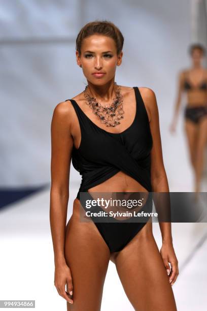 Model presents swimwear creation at the International Exhibition of Lingerie, 'Salon De La Lingerie' Summer Collection at Parc des Expositions Porte...