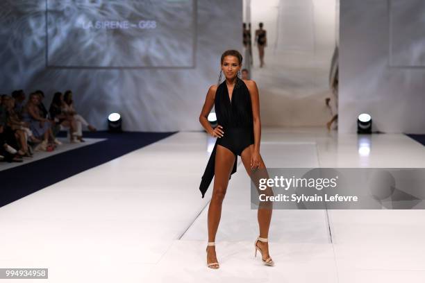 Model presents swimwear creation at the International Exhibition of Lingerie, 'Salon De La Lingerie' Summer Collection at Parc des Expositions Porte...