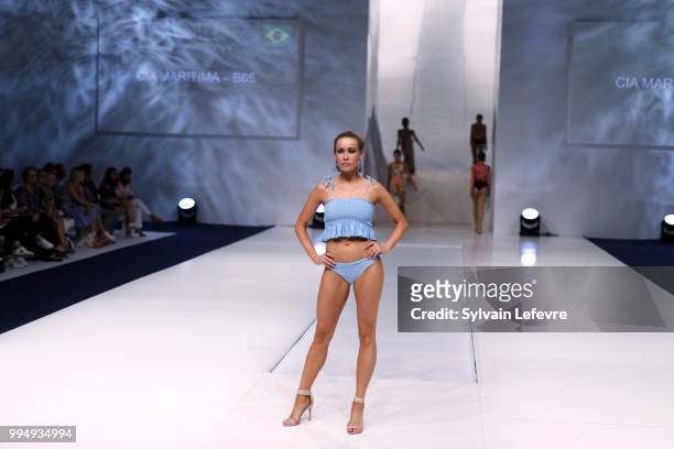 Model presents swimwear creation at the International Exhibition of Lingerie, 'Salon De La Lingerie' Summer Collection at Parc des Expositions Porte...