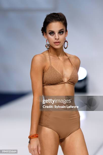 Model presents swimwear creation at the International Exhibition of Lingerie, 'Salon De La Lingerie' Summer Collection at Parc des Expositions Porte...