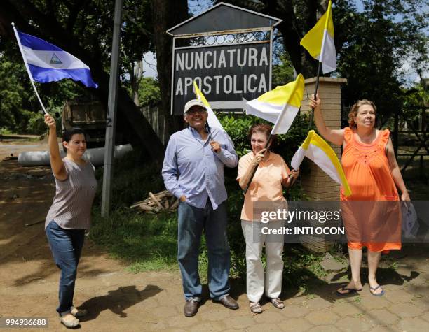 Faithfuls cheer as a caravan of the Catholic Church, including cardinal Leopoldo Brenes, passes by in Diriamba, Nicaragua, on July 9, 2018. -...